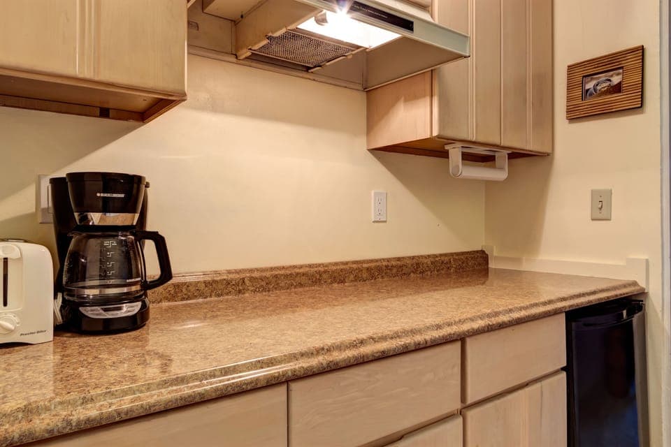 Breakfast bar with toaster, coffee maker, and blender.