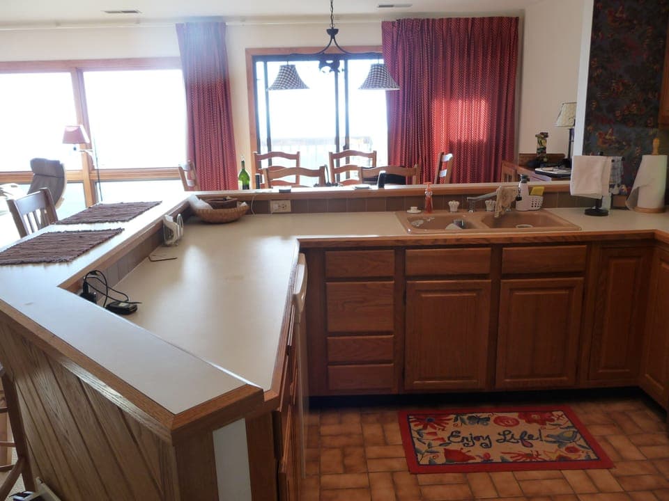 Kitchen view into dining area & deck