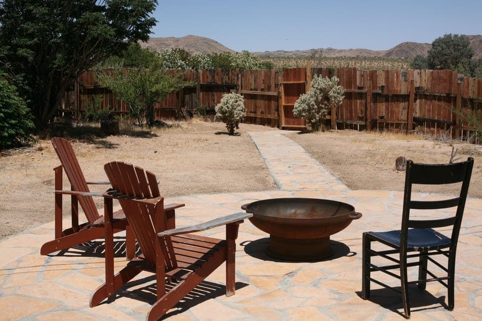 Spacious back yard with wood burning fire pit.