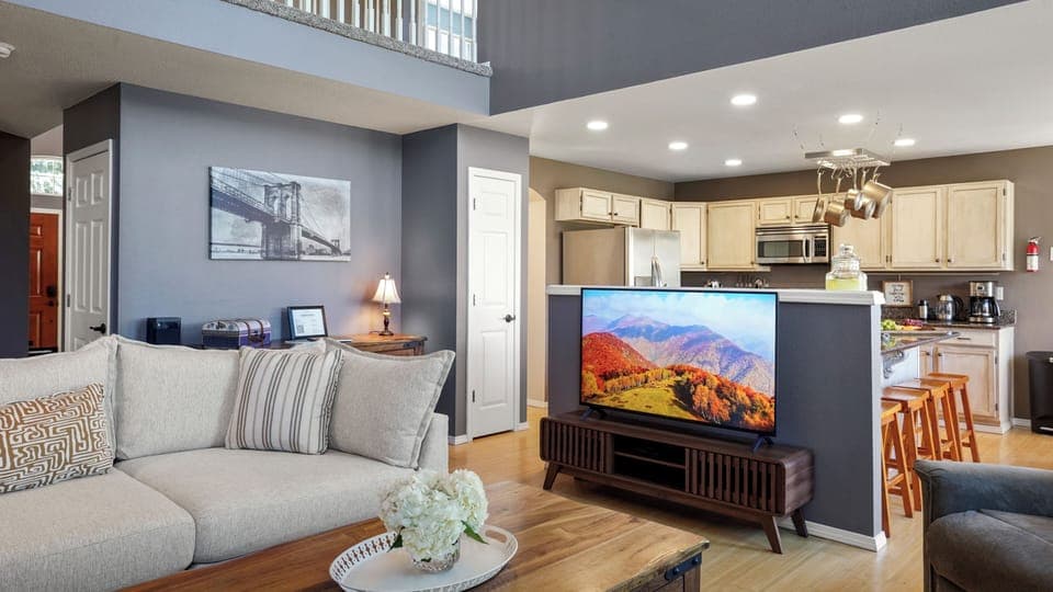 Living room with smart TV & cable access.