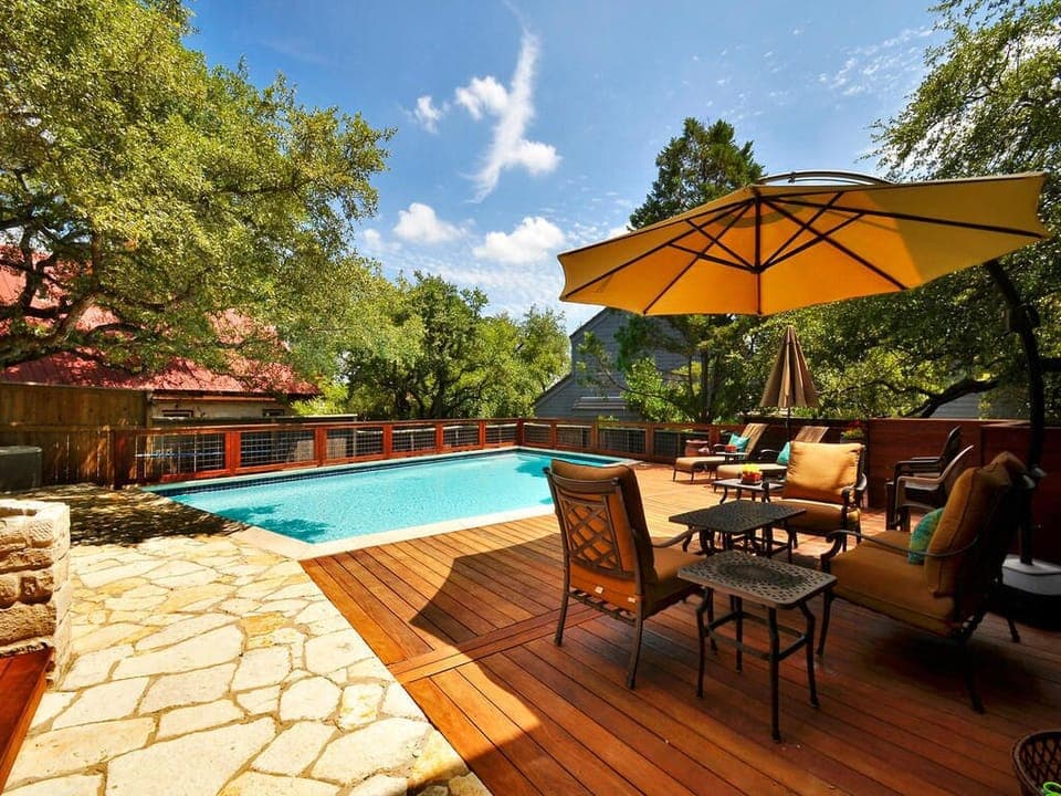 Large backyard area with pool, grill, dining and lounging area.  