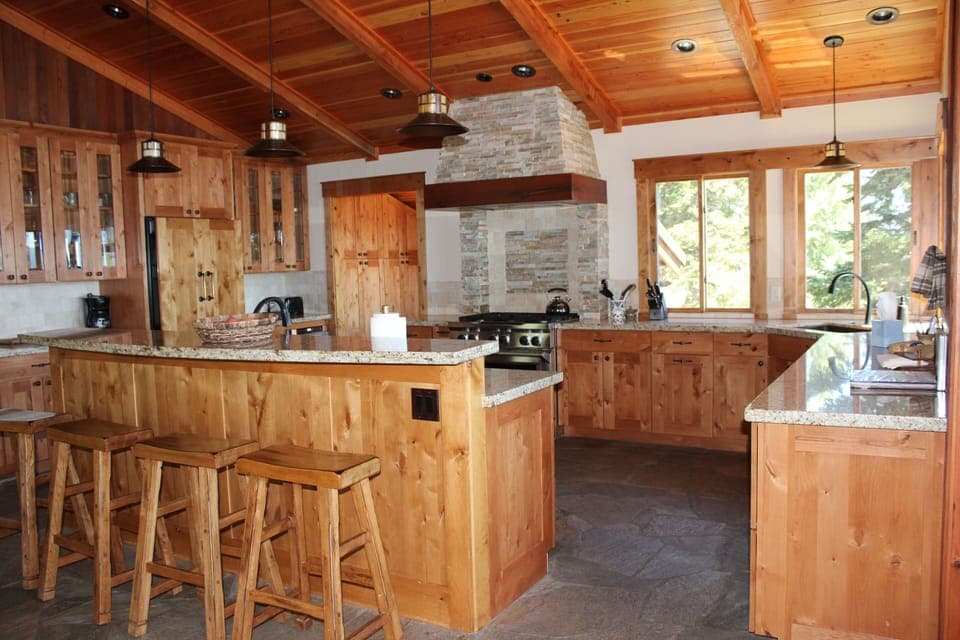 Kitchen with chef's stove, two dishwashers and island that seats 4