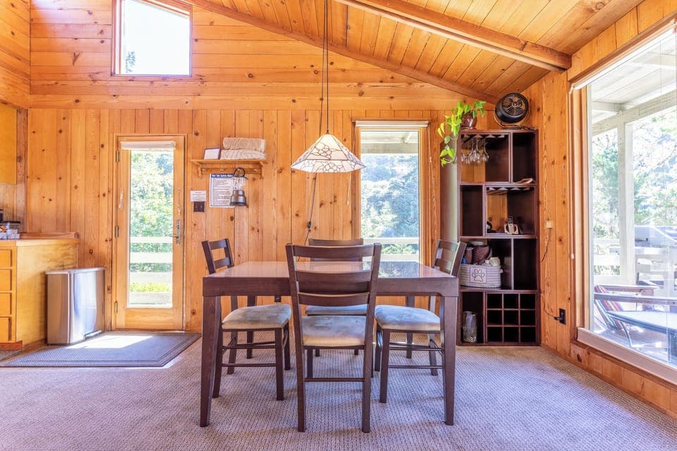 Indoor dining area with a door to the deck.
