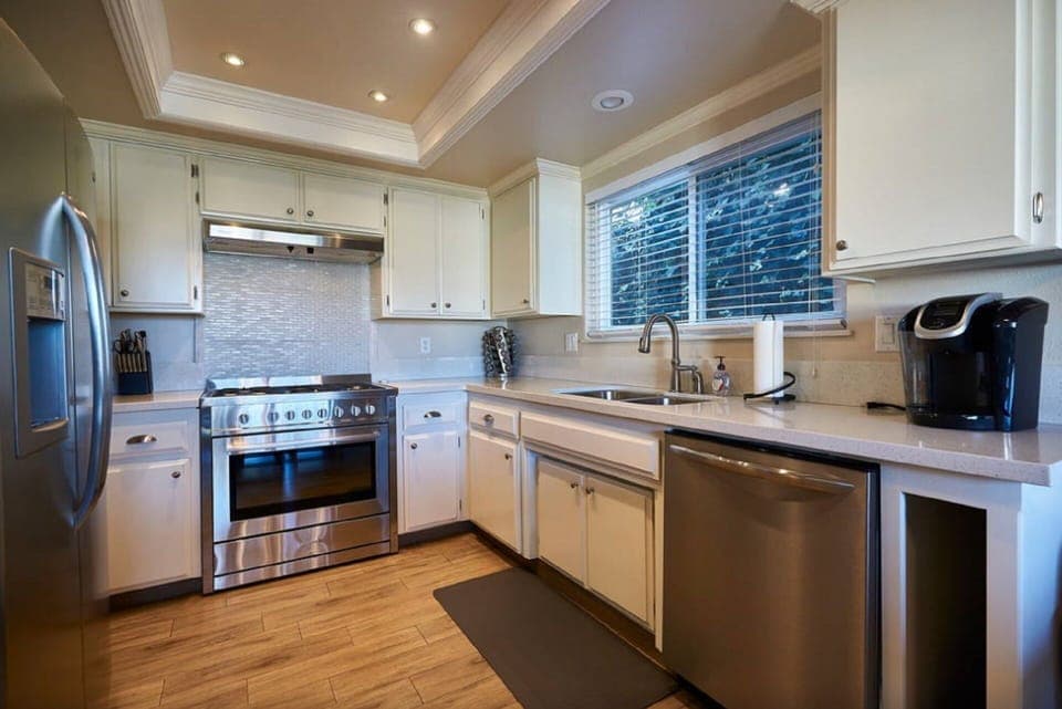 Kitchen with professional grade stove and oven, dishwasher and Keurig.
