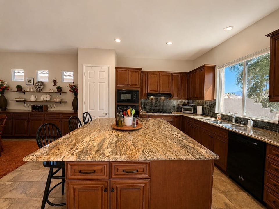 Modern, fully stocked kitchen with quality appliances, cookware, and spices