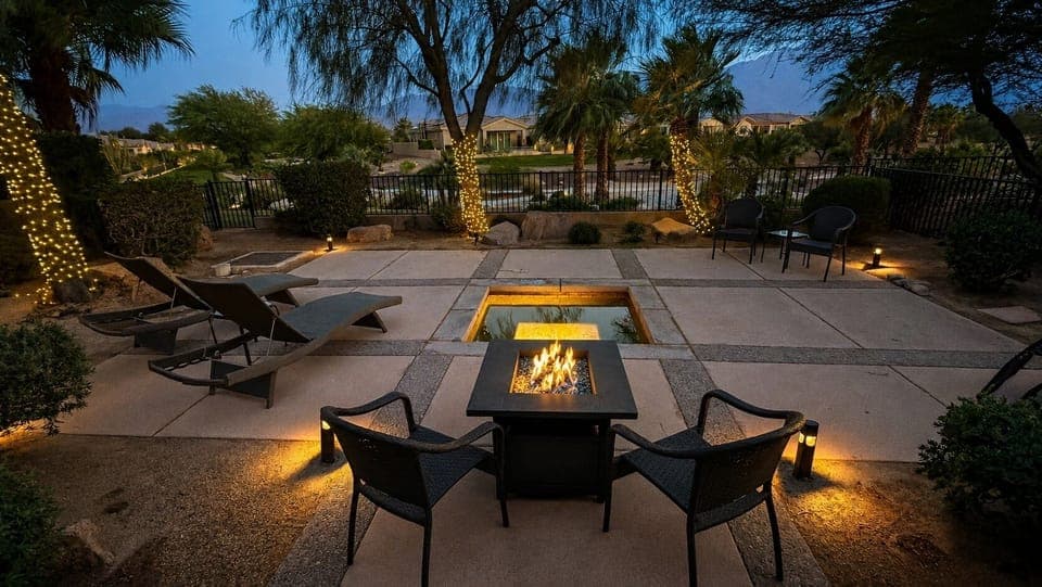 Twilight backyard retreat with spa and fire pit.