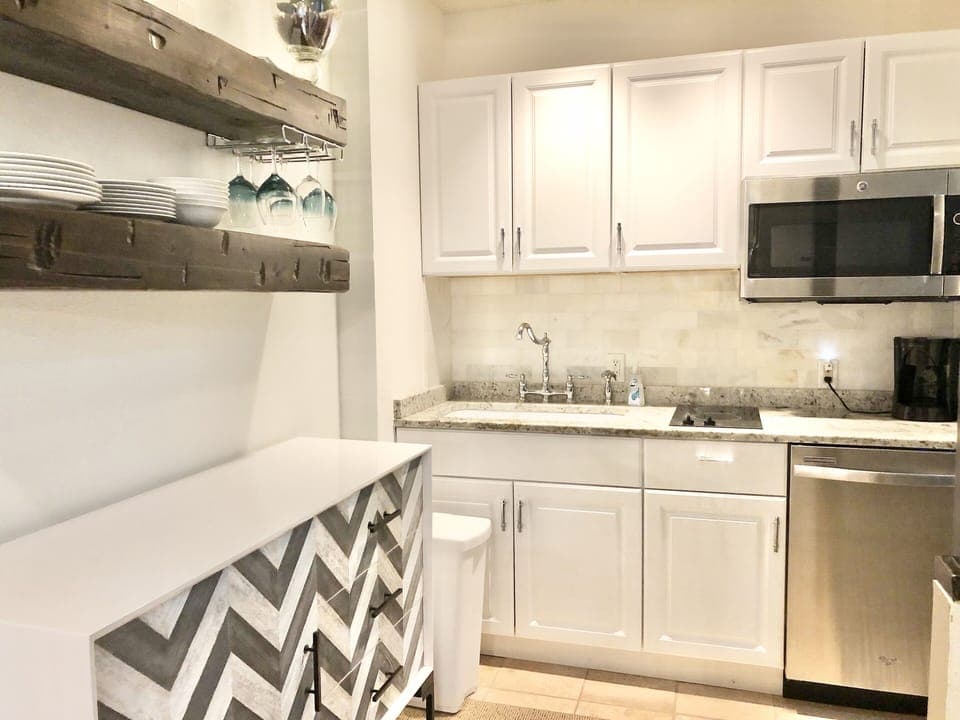 Kitchenette: convection oven, 2 burner stove, microwave, and full sized fridge