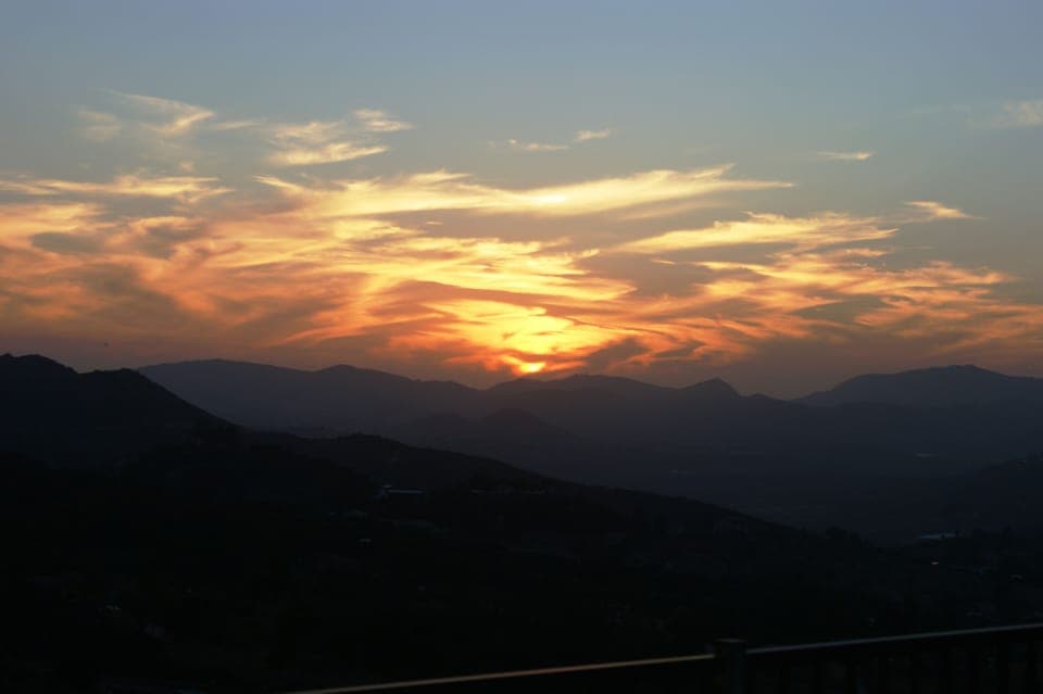 View from the back patio, sunroom, deck, game room and 3 bedrooms at sunset.