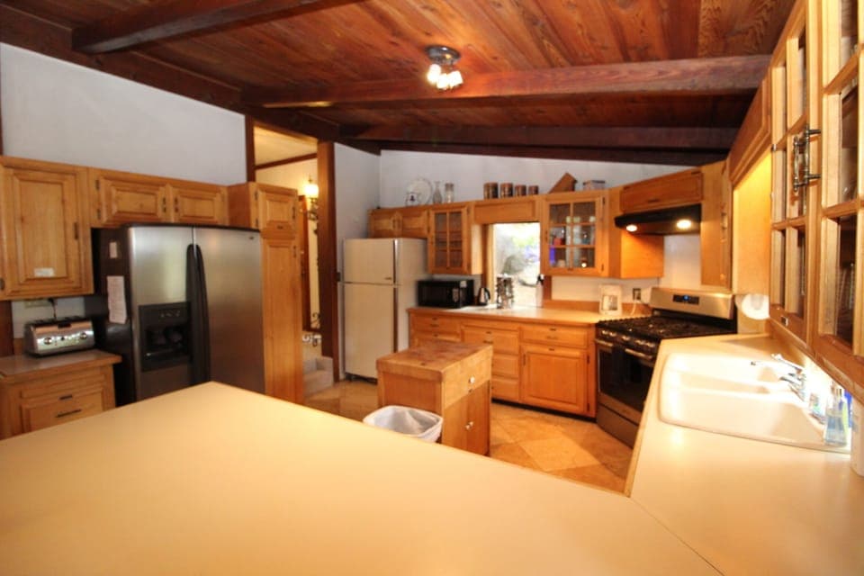 Kitchen: 2 refrigerators,. double sink, gas range, microwave, dishwasher.