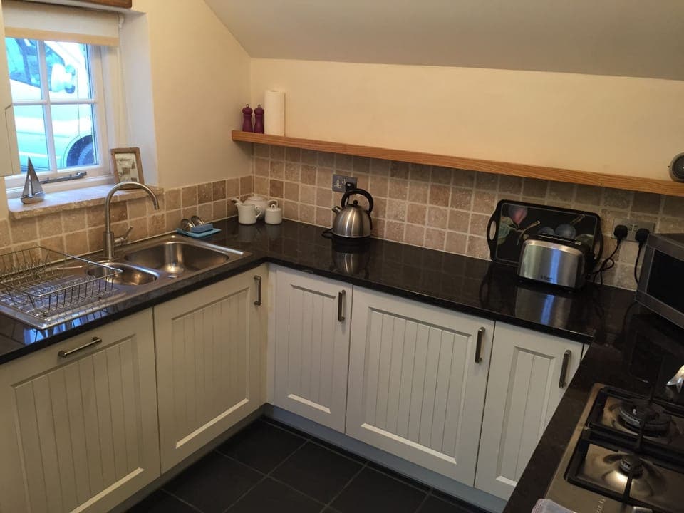 Modern kitchen with dishwasher, washing machine, gas hob & electric double-ove