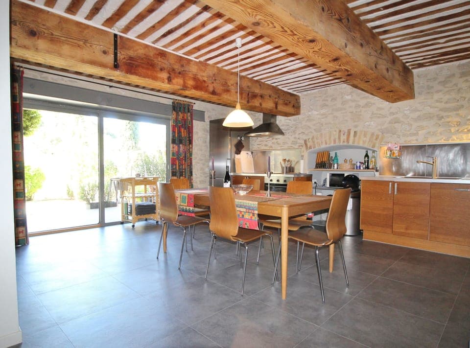 Kitchen & dining area with large glass sliding door to terrace and pool court