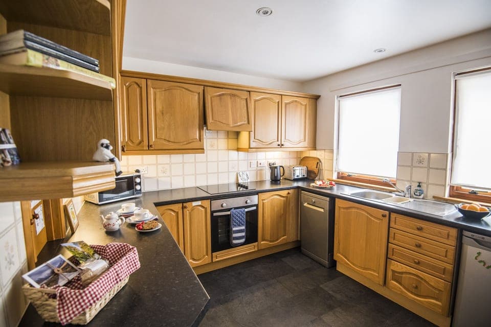 well equipped kitchen with hob, oven, fridge, dishwasher, microwave