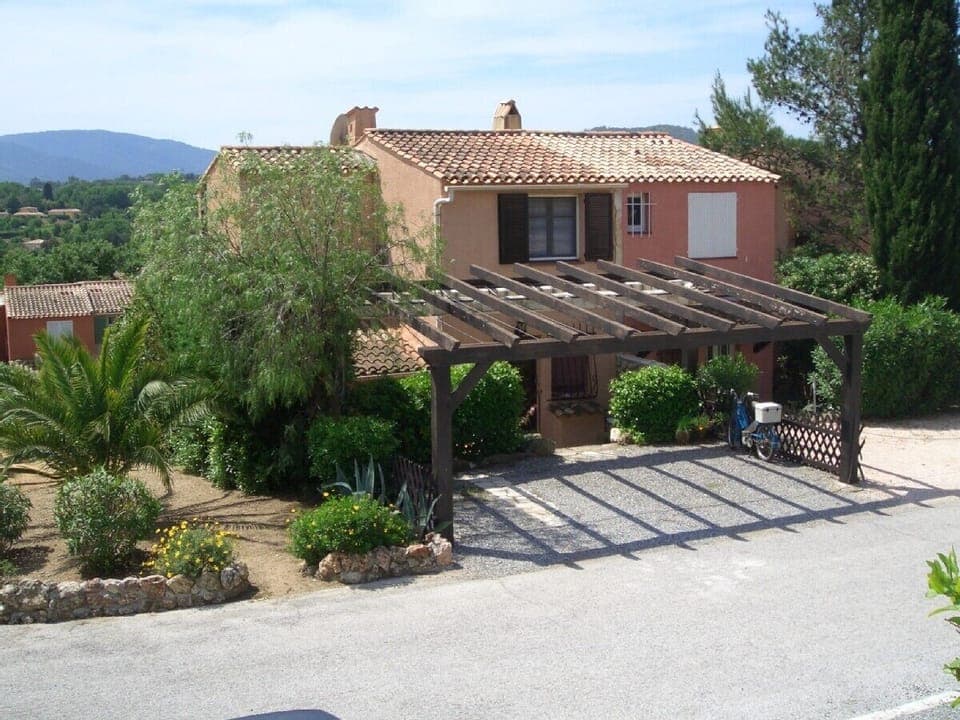 The house is on the left hand side, with the shaded parking.