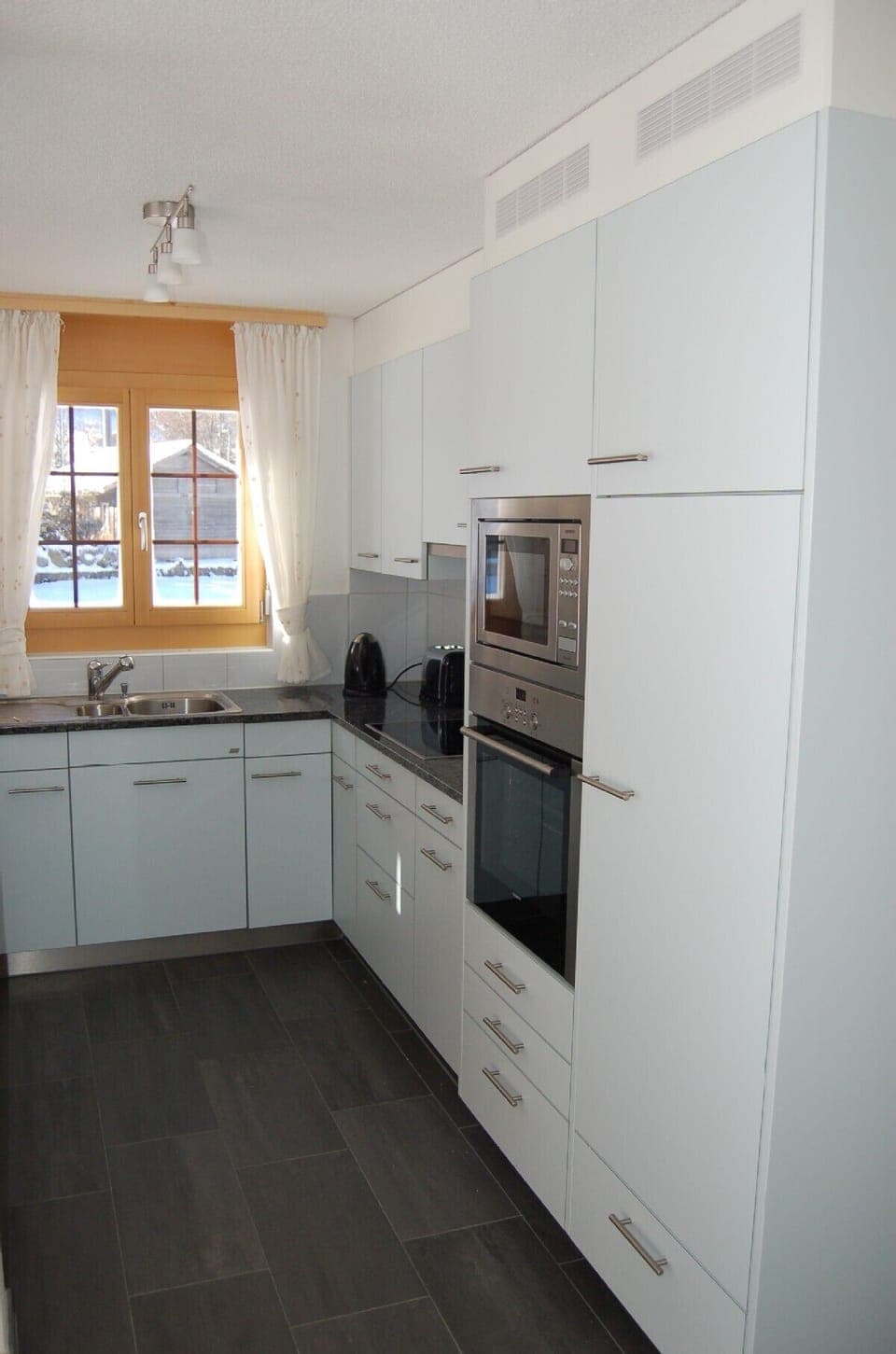 Black granite and stainless steel modern kitchen