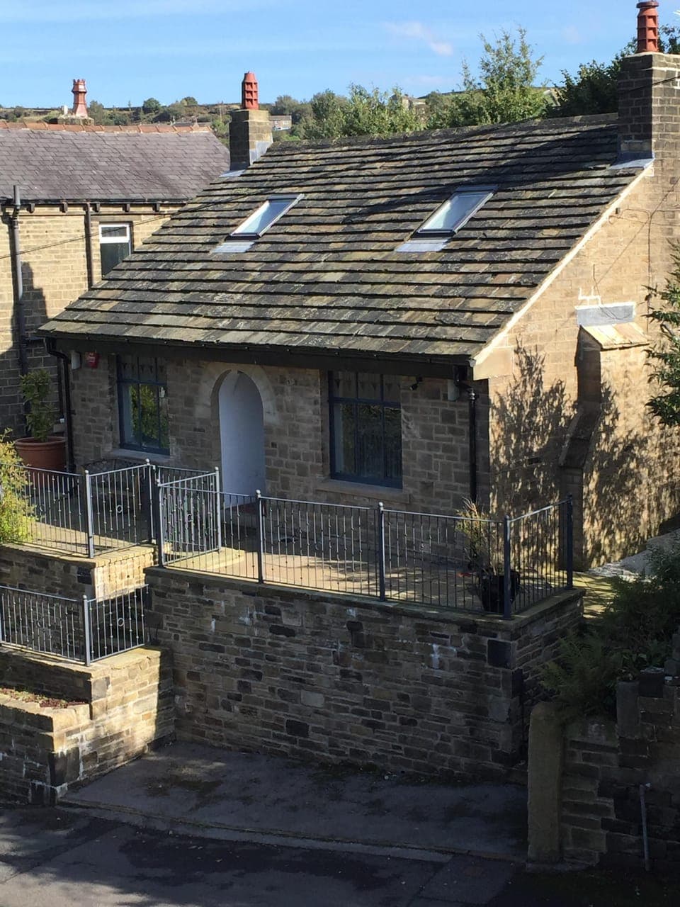 Another view of cottage front showing small parking area to front