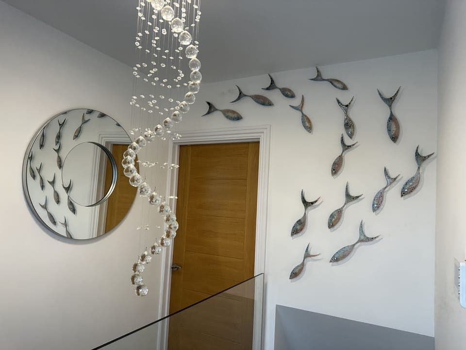 Jo Downs glass fish over stairwell 