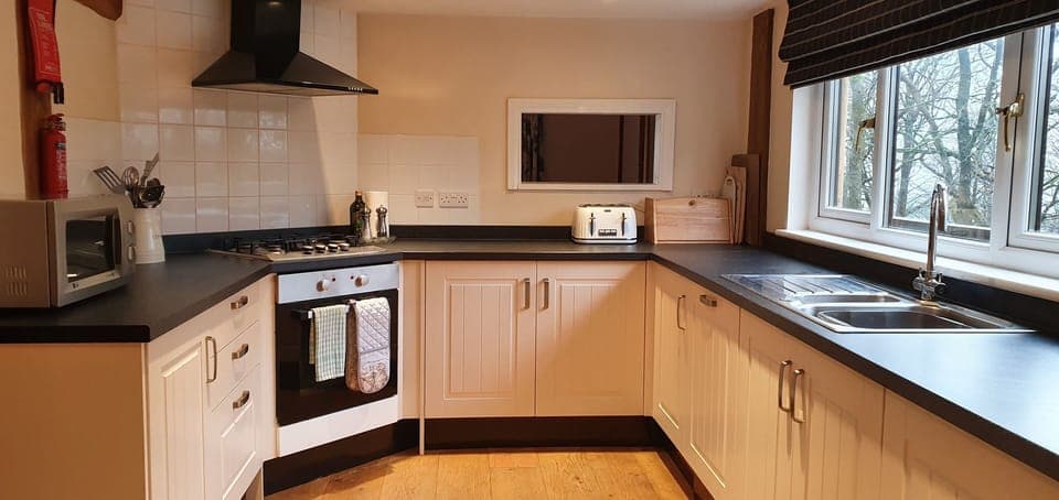 Kitchen showing serving hatch to dining area