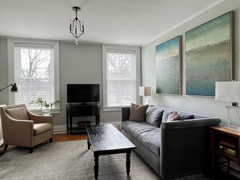 Living room with queen sleeper sofa and workspace (desk not pictured)