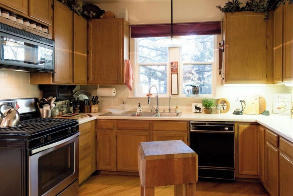Kitchen with gas range, dishwasher, microwave, toaster oven, and Nespresso