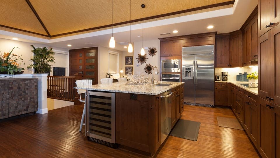 Gourmet kitchen equipped with high-end appliances, built in wine fridge, essential, cookware and a nice assortment of spices and oils.