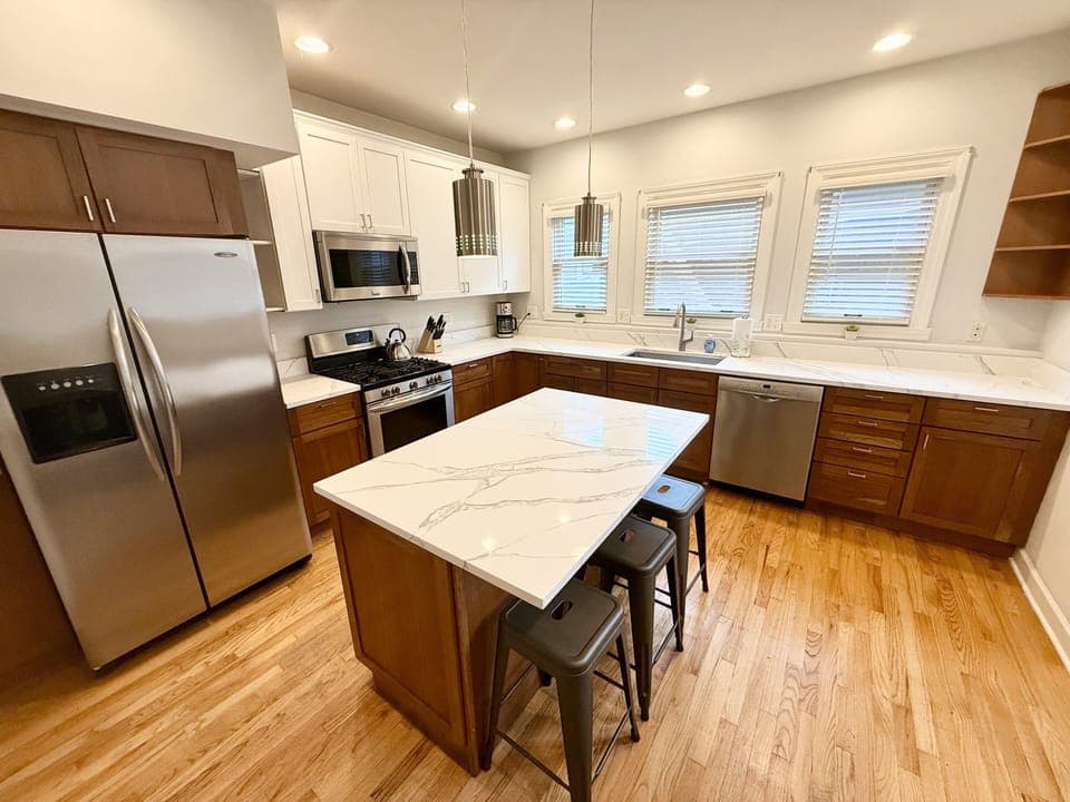 Kitchen with center island, quartz countertops, stainless appliances