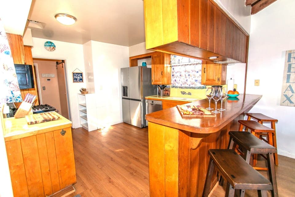 Cozy breakfast bar offers extra seating for four. Large refrigerator and dishwasher for added convenience.