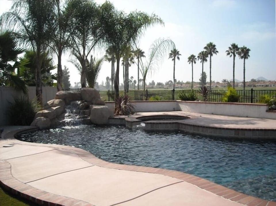 Swimming pool and spa with rock waterfall