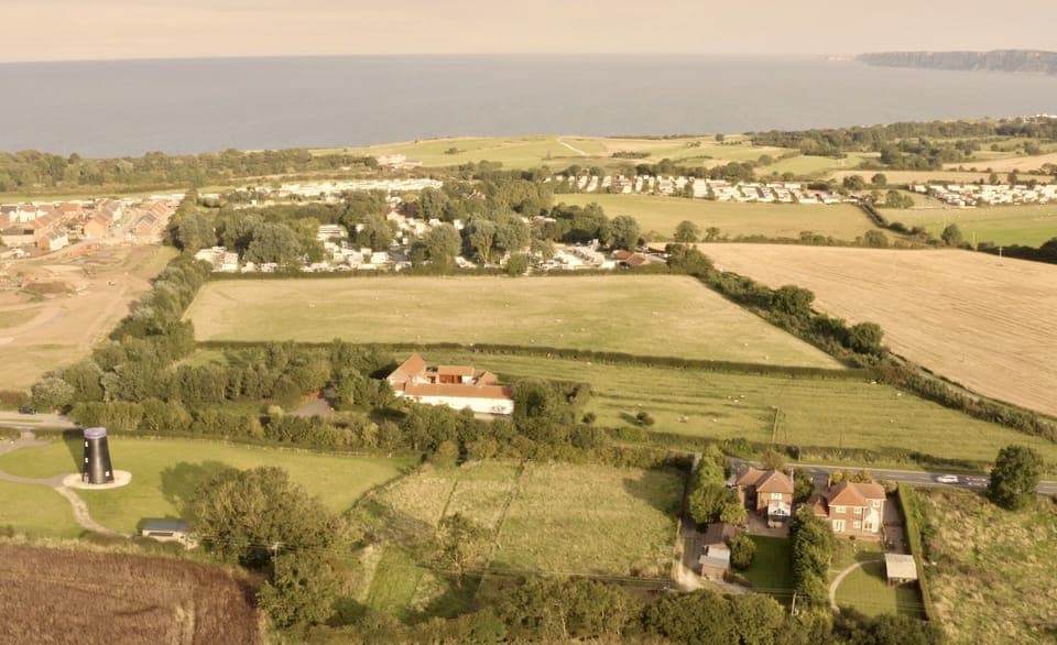 Mill Farm is the middle property to the right of the windmill
