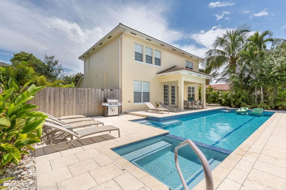 Home on the river with 42 ft solar heated salt water lap pool and spa