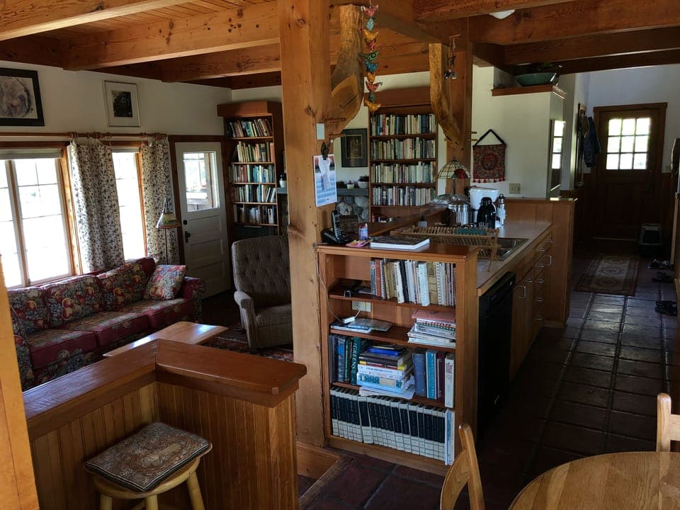 View from side porch into living room, kitchen, and dining area