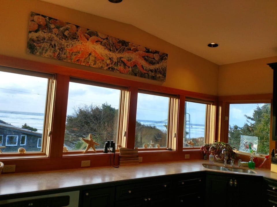 Wall to wall kitchen windows provide panoramic ocean views. Sunset views!