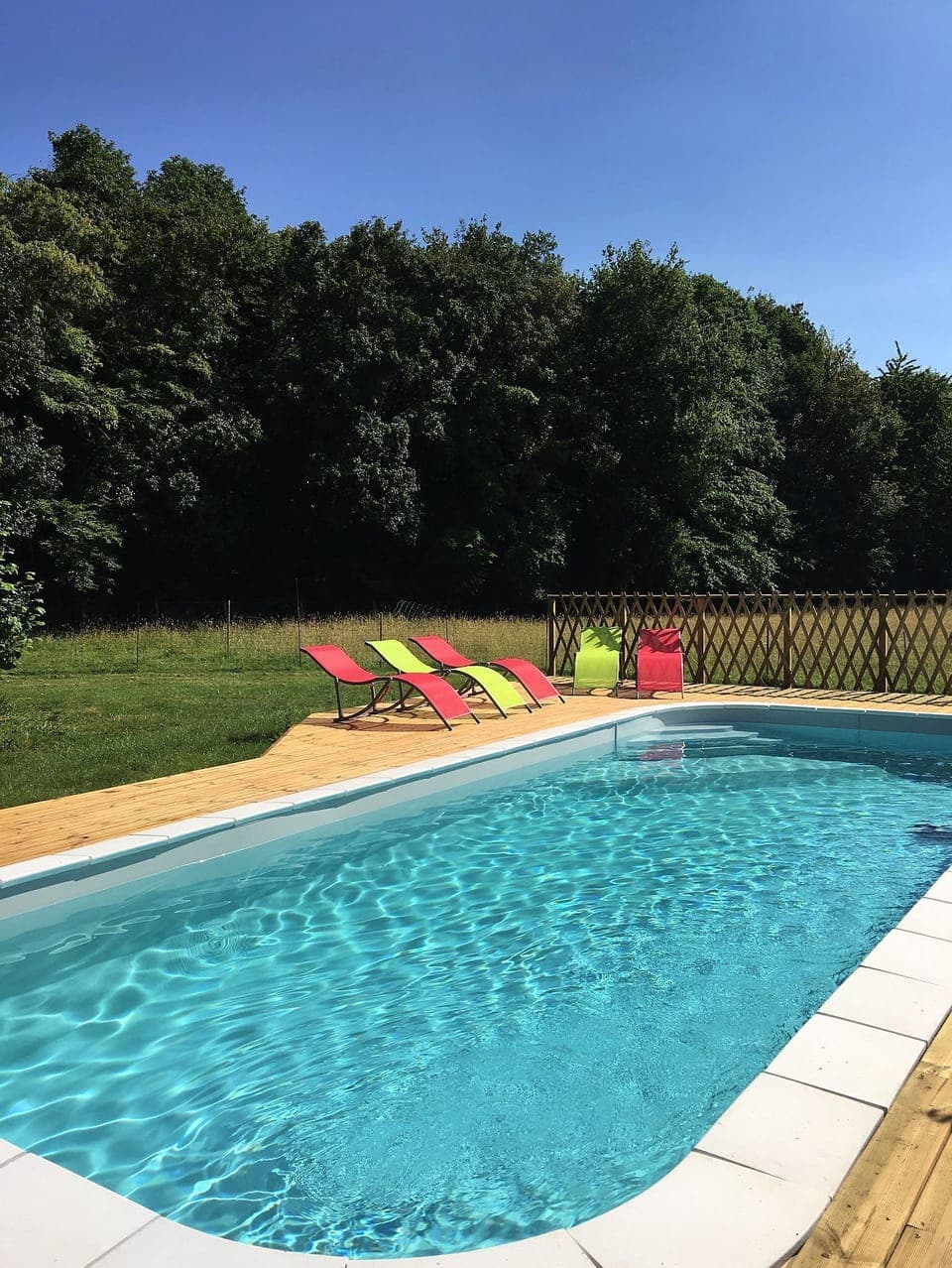 Deck chairs around swimming pool