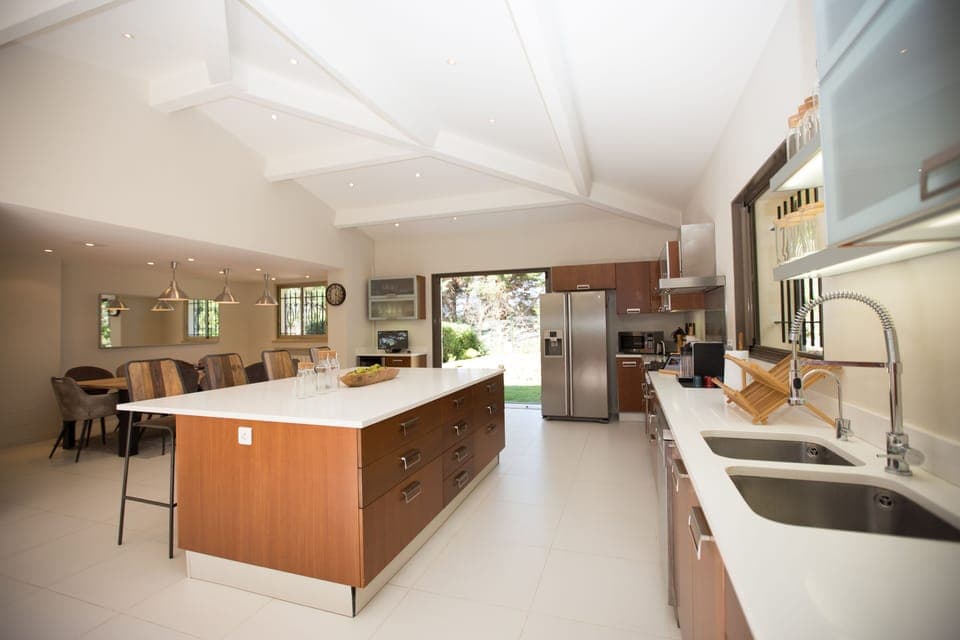 A huge state-of-the-art kitchen and dining room with  high-ceilings.