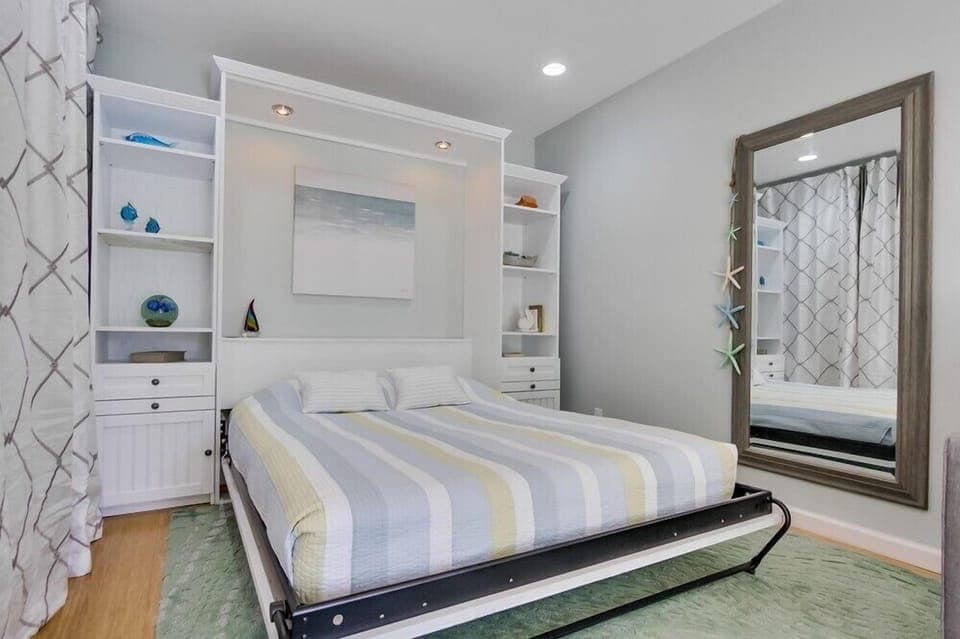 Custom built murphy bed with built in reading lights and pullout night stands.