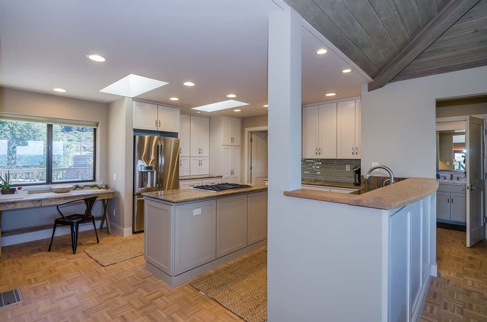 This view of the kitchen shows an extra table to the far left - great for office