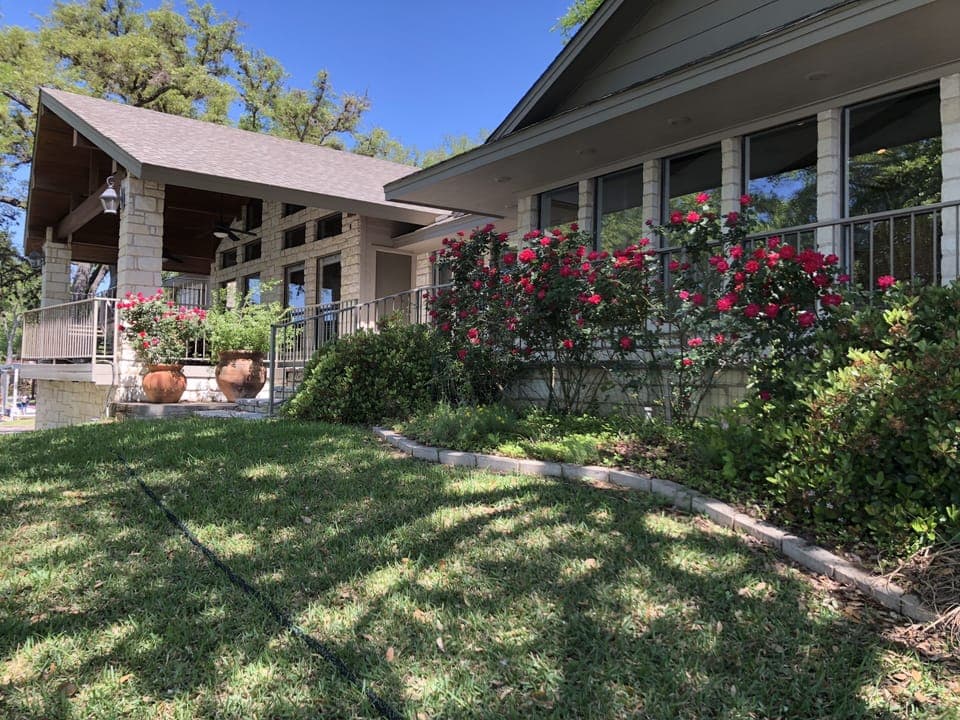 One wing of home facing lake - master bedroom and living room windows shown here