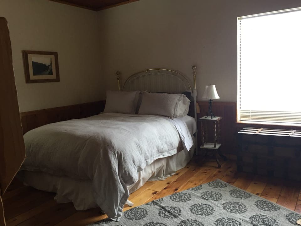 Queen size bed with plush down comforter.