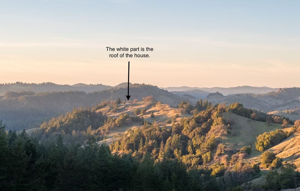 White roof is the ranch house nestled into surrounding ranch land.