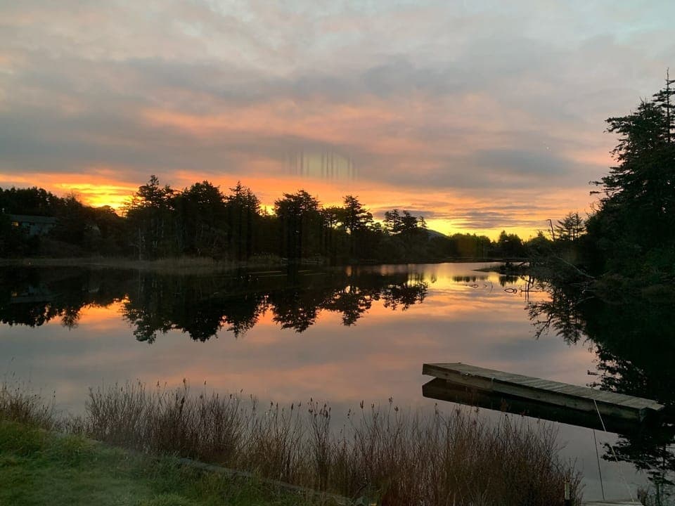 SUN COMING UP OVER THE LAKE