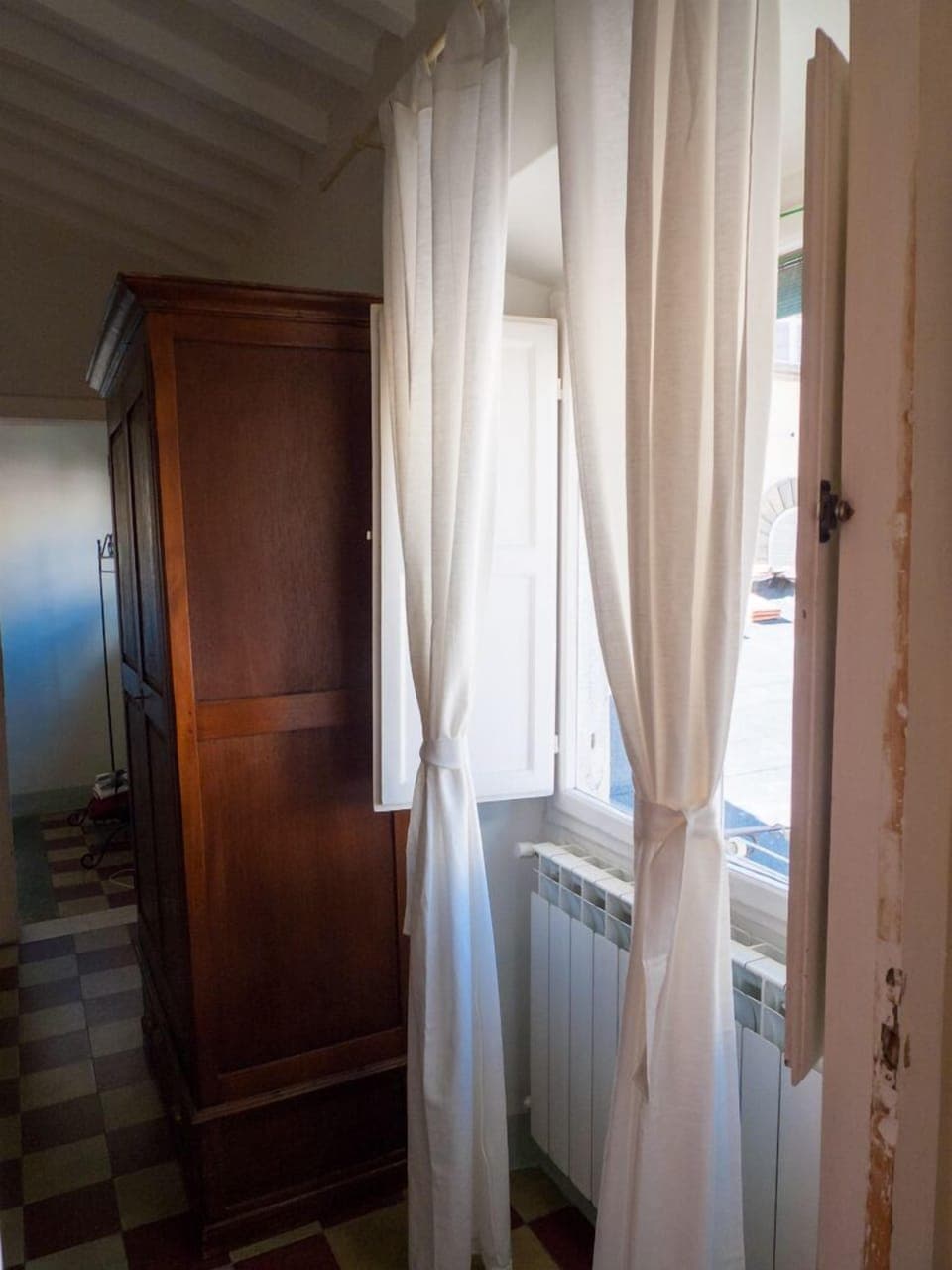 Master bedroom window looks out over Lucca's rooftops