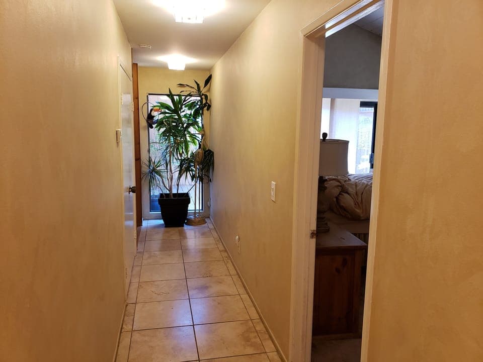 Looking from outside laundry room to West, Master bedroom door, entry ahead