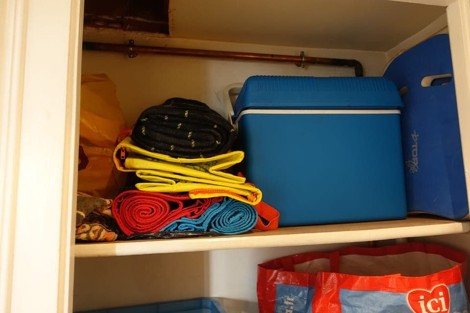 Hallway closet - upper shelf. Beach items.