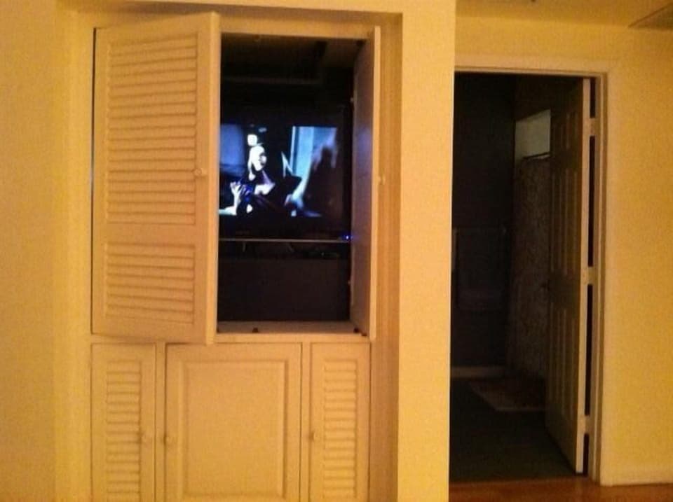 lg flat screen smart tv hidden in armoire...doors slide in or open out