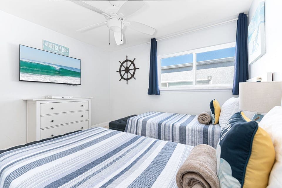 This twin bedroom offers a cheerful escape where children or additional guests can relax, recharge, and enjoy a restful night’s sleep
                