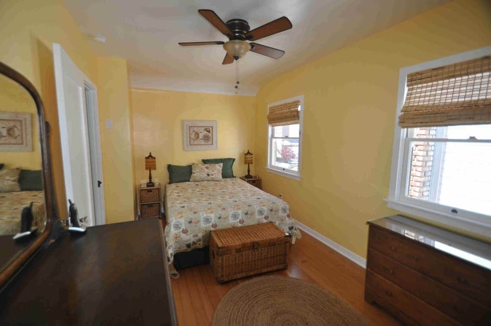 The queen bedroom with refinished wood floors,vintage dresser and walk-in closet