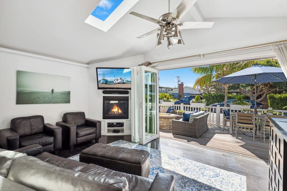 Open living room and deck with accordion doors, creating an indoor/outdoor space