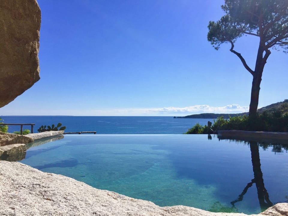 Our infinity pool, carved off the granite stone, has a stunning view of the bay.