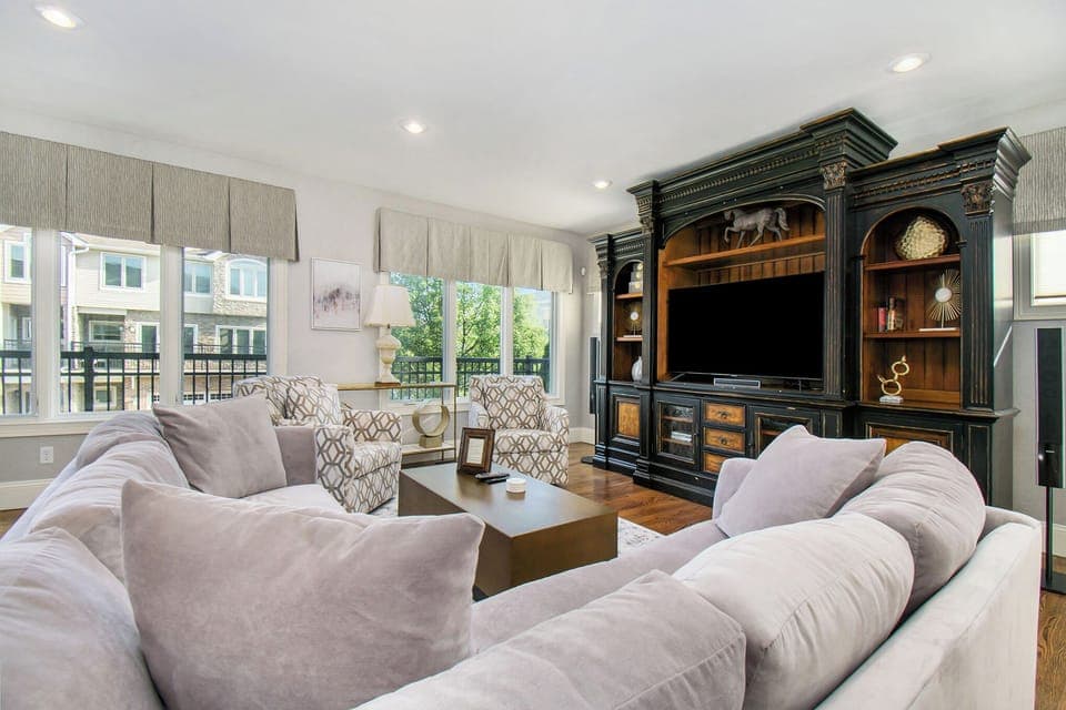 Fully remodeled upstairs living room with bar area and balcony.