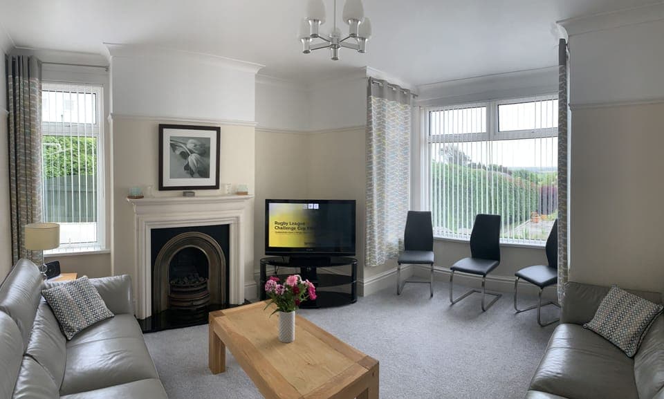 Large lounge looking onto sunny south facing fenced private garden