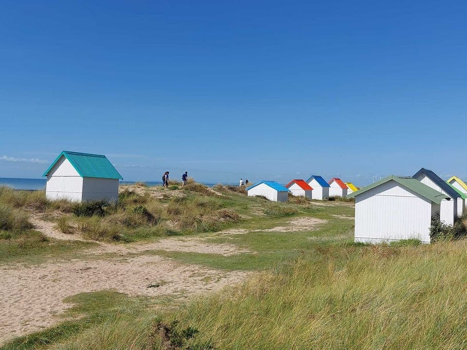 Colouful beach huts at Gouville.
